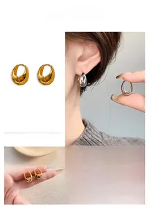 Detail of minimalist teardrop geometric earrings in gold and silver mirror finishes