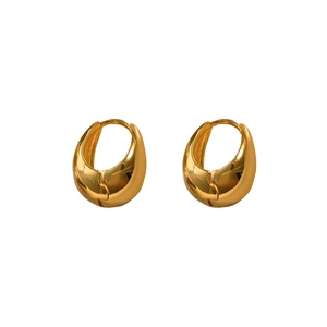 Macro detail of chunky gold plated hoop earrings with a mirror polished finish