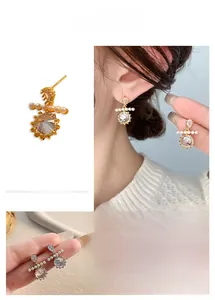 Detailed view of teardrop crystal and round cut zircon earrings with small pearls