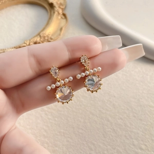Elegant vintage gold earrings with sparkling drop-shaped stones and white pearls