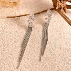 Macro detail of long silver tassel earrings with sparkling zircon waterdrop accents