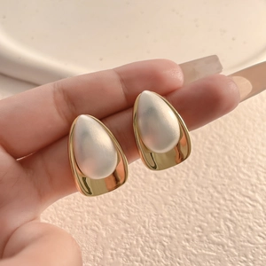 Minimalist gold and pearl teardrop earrings with brushed metal finish for women