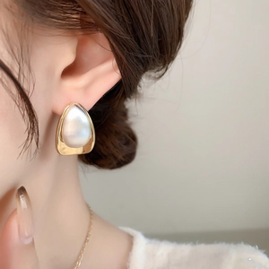 Minimalist gold and silver teardrop stud earrings with brushed metallic finish