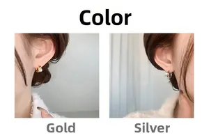 Close-up of gold and silver irregular textured hoop earrings with white pearls