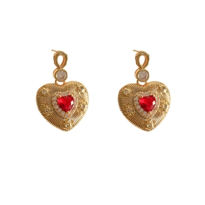 Vintage gold earrings with large red heart pendant and radiant sunburst engraving