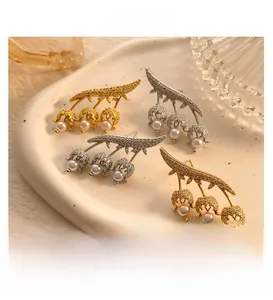 Detailed view of lily of the valley earrings with pearls and zircon in gold and silver