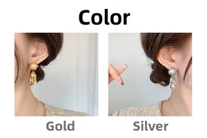 Detail view of pearl tassel earrings in gold and silver finishes on a model