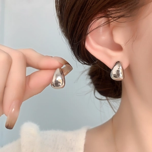 Polished silver water drop stud earrings with a minimalist sleek metallic finish