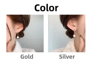 Detail view of gold and silver pearl drop earrings showing elegant metallic finish and luster