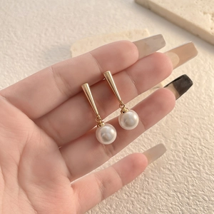 Elegant 18K gold plated pearl drop earrings featuring minimalist cone design and high luster