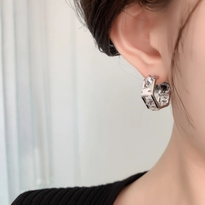 Side view of silver geometric hoop earrings with double-sided micro-pave cubic zirconia