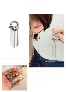 Detail of long chain tassel earrings with metallic sequins in gold and silver finish