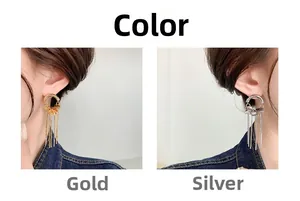 Detail of elegant gold and silver tassel earrings showing length and fluid metallic chain drape