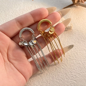 Chain tassel earrings in gold and silver finish featuring sleek U-shaped metal studs