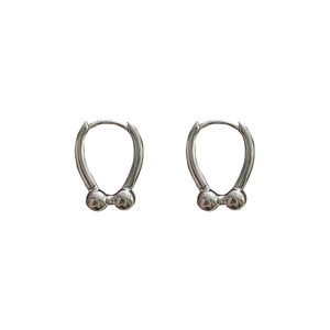 Minimalist silver horseshoe earrings with metal beads in a stylish industrial design
