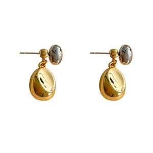 Minimalist gold and silver two-tone bean earrings in polished 18K gold plated copper