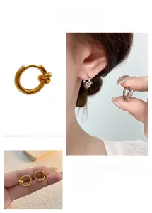 Detailed close-up showing knotted geometric gold and silver hoop earrings on a model