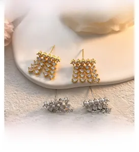 Macro shot of tassel drop earrings featuring high-clarity cubic zirconia and 18K gold plating