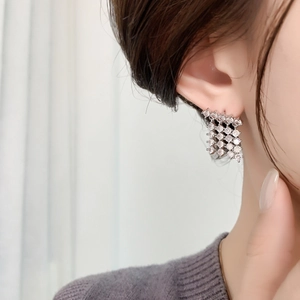 Macro detail of geometric square earrings with full cubic zirconia stones on model