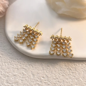Detailed macro shot of 18K gold plated zircon earrings with sparkling fringe dangles