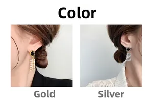 Detail of luxury fringe earrings with black stone and 18K gold plated zircon tassels