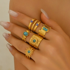 Five-piece vintage gold boho ring set with sunburst motifs and turquoise accents