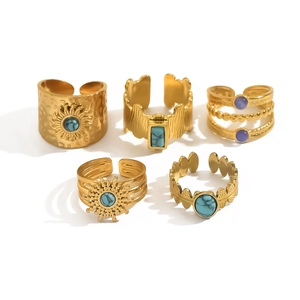 Five-piece vintage gold ring set with sunburst motifs and colorful gemstone inlays