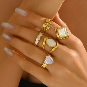 5-piece gold ring set featuring butterfly, heart enamel, and opal gemstones on fingers
