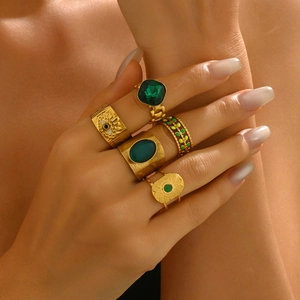 Vintage gold ring set with green gemstones and bohemian evil eye engraving for women