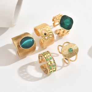 Vintage 5-piece gold stackable ring set with green emerald and evil eye charms