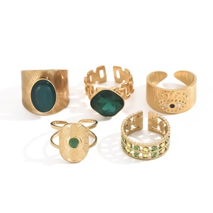 Vintage gold adjustable rings set featuring emerald green stones and evil eye details