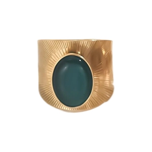 Close-up of vintage gold ring featuring an oval green stone and sunburst textured metal