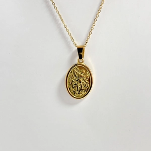 Close-up of 18k gold plated St. Michael relief pendant with detailed oval engraving