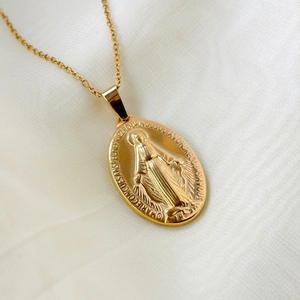 Vintage Roman coin pendant necklace in gold stainless steel on white silk background