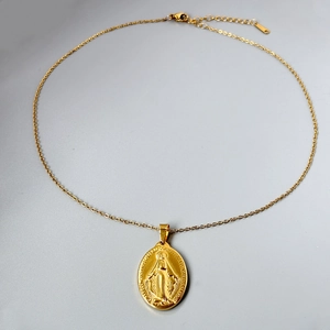 Golden oval Virgin Mary medal pendant necklace with intricate religious relief and thin chain