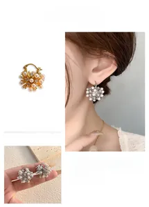 Detail of gold and silver plated snowflake pearl earrings with sparkling rhinestones