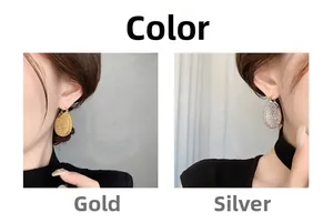 Hollow teardrop earrings shown in gold and silver finishes on model for style comparison