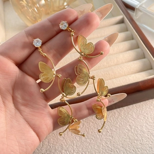 Silver needle butterfly tassel earrings with cubic zirconia and gold hollow design
