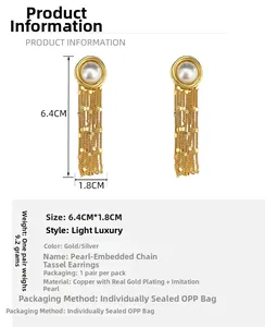 Detail view of gold-plated waterfall tassel earrings with pearls and size measurements