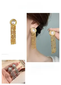 Detail of long tassel earrings with metallic chain sequins and white round pearls