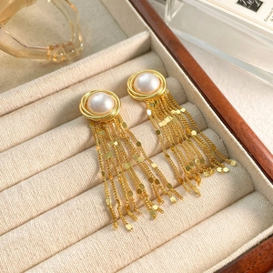 Detail of gold waterfall tassel earrings with white pearls and shimmering sequins