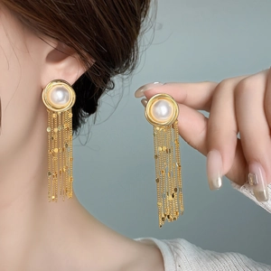Elegant gold tassel earrings with large pearl stud and cascading shimmering metal chains