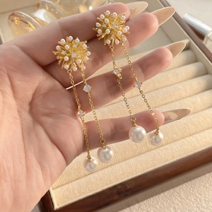 Long gold tassel snowflake earrings with pearls and zircon crystals for an elegant look