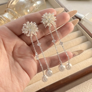 Detail view of long pearl tassel earrings with shimmering crystals and elegant silver finish