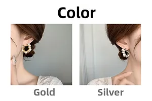 Detailed comparison of gold and silver C-shaped earrings with inlaid white pearls on model