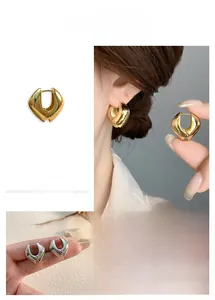 Gros plan de boucles d'oreilles créoles géométriques dorées et argentées polies