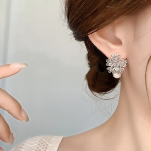Elegant floral micro-pave zircon stud earrings with white pearl drop on female model