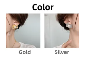 Close-up of matte metal pleated flower earrings with pearls in gold and silver colors