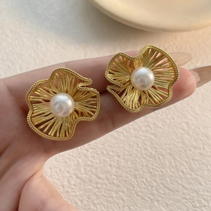Matte gold floral pearl stud earrings with textured petals and elegant hollow design