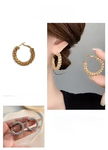 Detail of wheat ear hoop earrings with sparkling zircon inlay in gold and silver finish